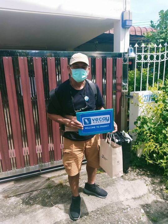 Veecay Phuket Taxi Driver holding company signboard in his hands