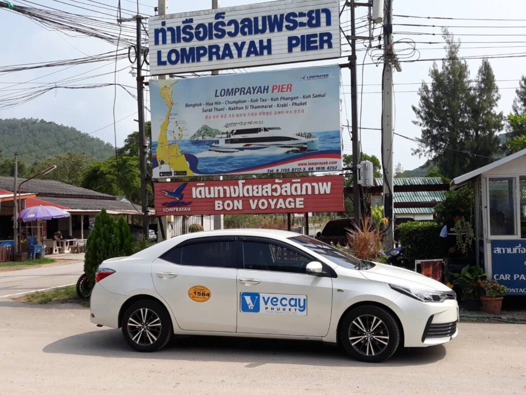 Veecay Phuket taxi company vehicle parked under a sign.