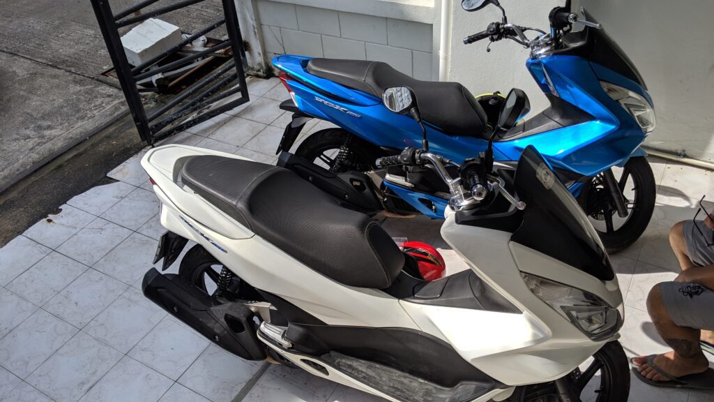 A pair of PCX 150 motorbikes parked side by side
