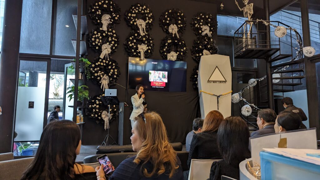 Host gives speach on stage at the Kid Mai Death Cafe Launch Day