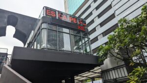 Escape room sign on top of the Kid Mai Death Cafe Building