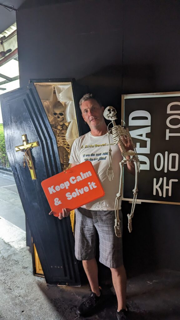 DJ proudly displays a sign after a successful escape from one of the challenging escape rooms