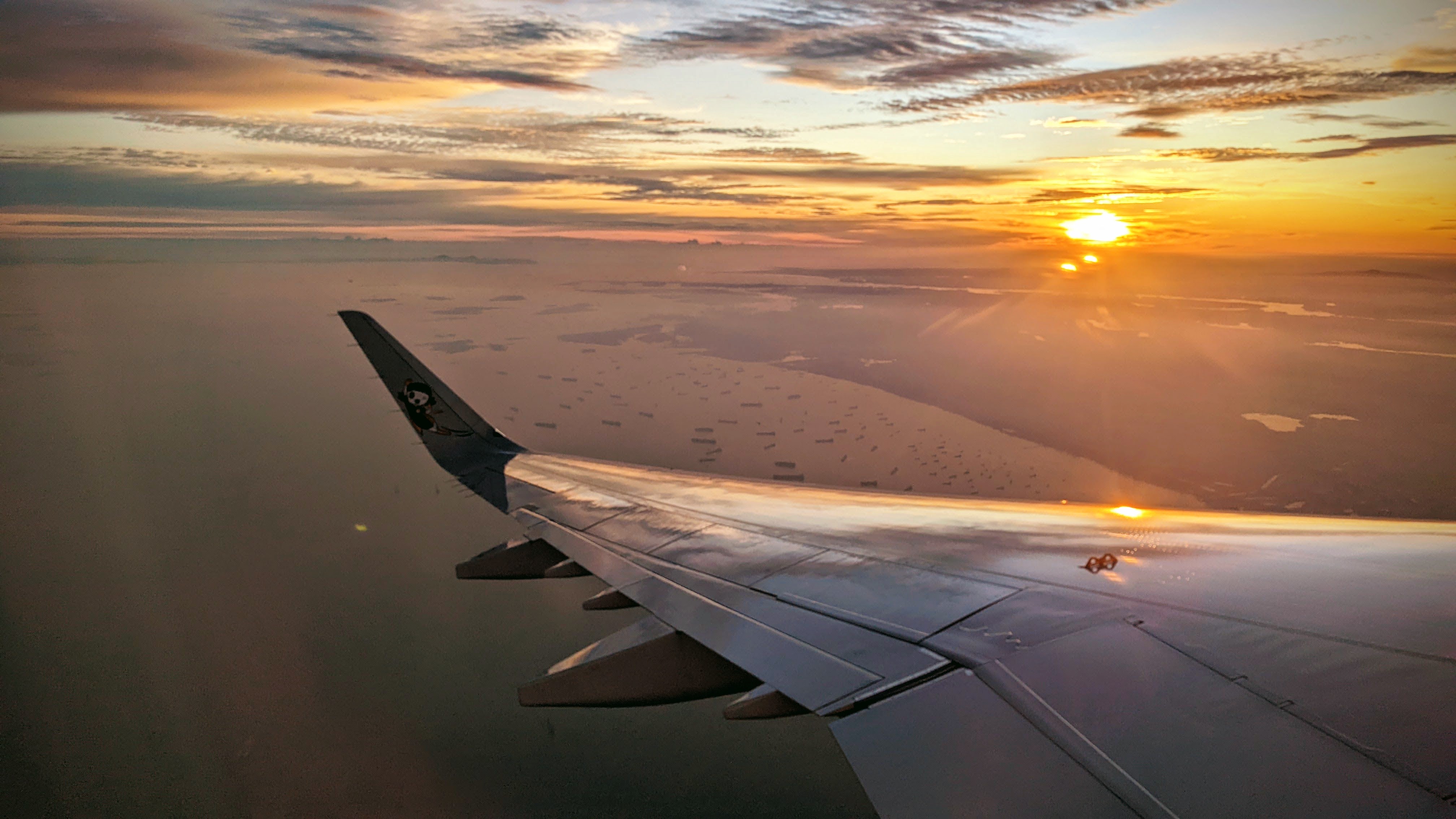 Looking out the window of Jet during sunset over the Ocean