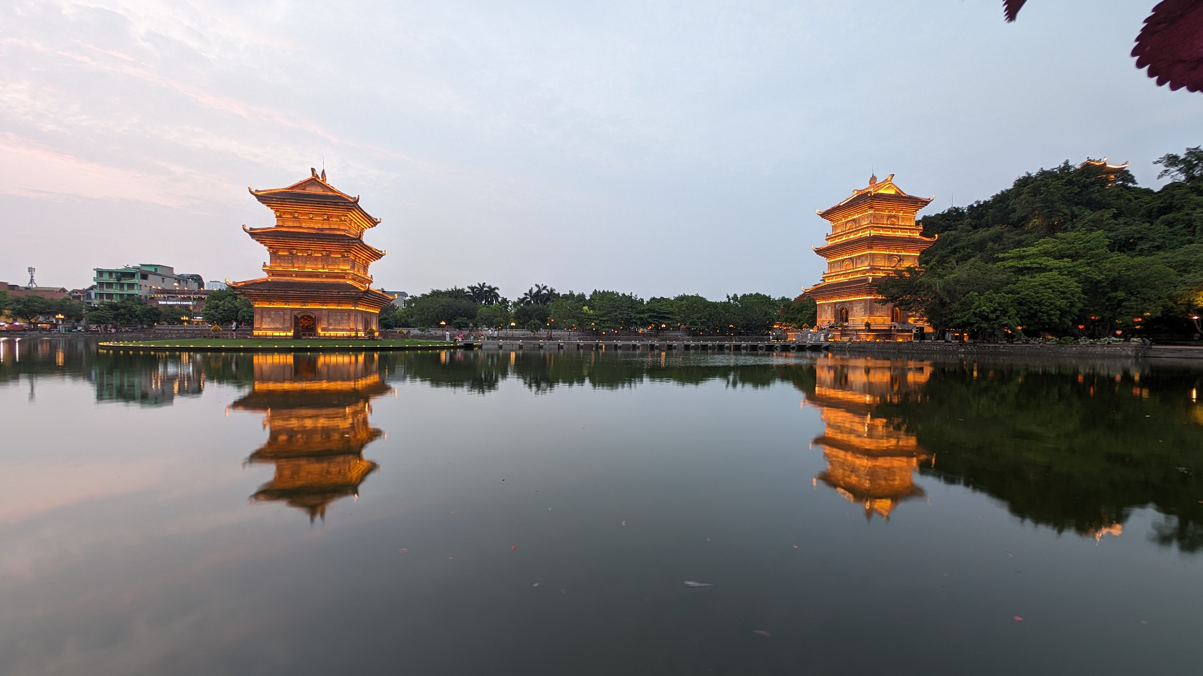 view accross the lake at Hoa Lu Ancient Town in Ninh Binh with the tower lit up and dusk